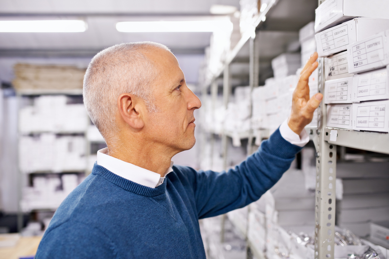 man choosing products off a shelf